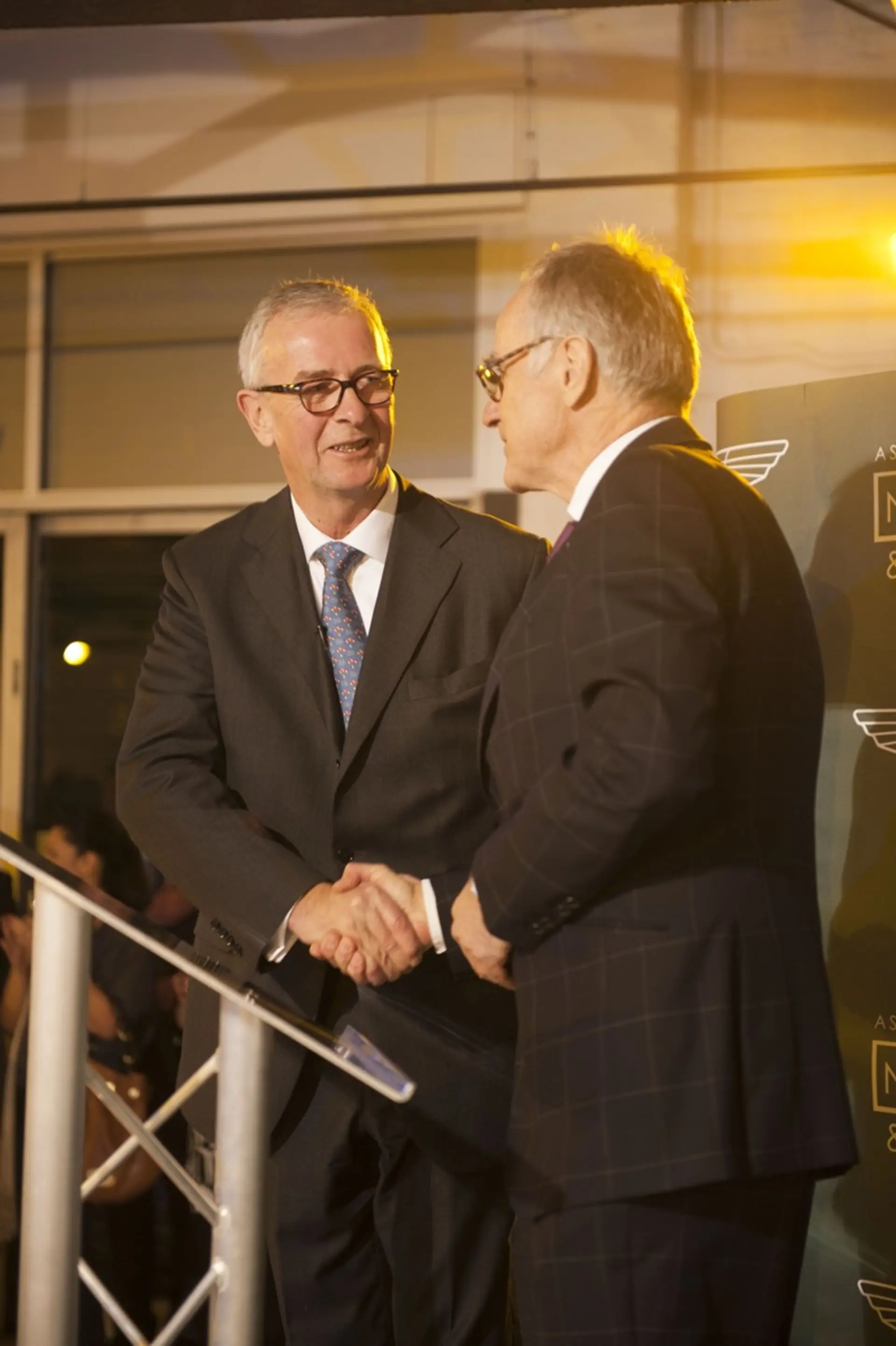 Nicholas Mee (left) shakes hands with Dr. Ulrich Bez