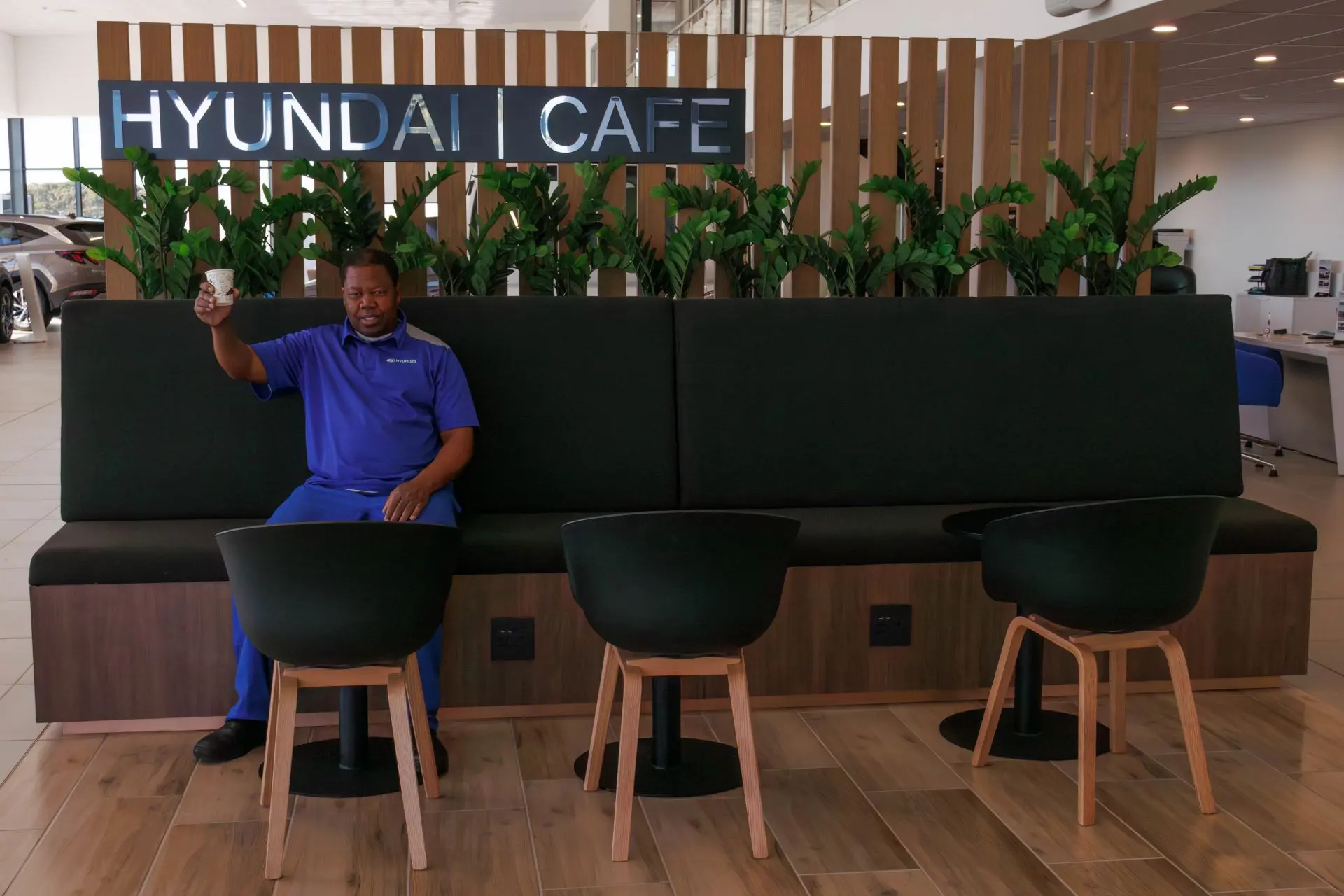 Kelston Motor Group Employee Melvin Koko Enjoys A Coffee At The Hyundai Cafe In The New Dealership